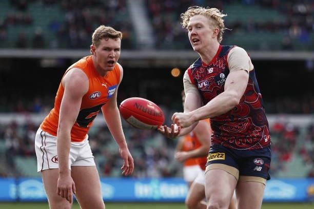 Clayton Oliver of the Demons handpasses the ball during the 2021 AFL Round 16 match between the Melbourne Demons and the GWS Giants at the Melbourne...