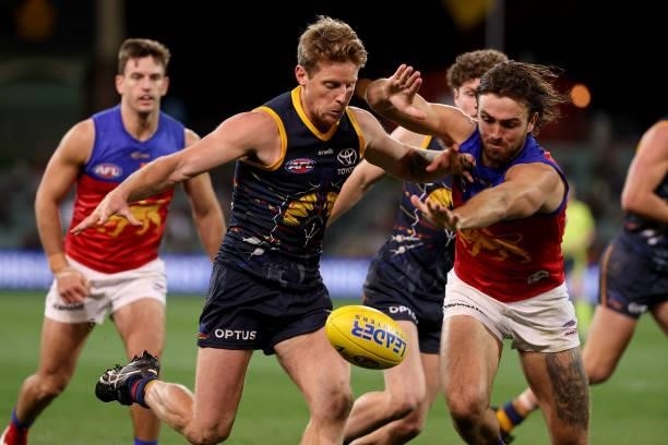 Rory Sloane of the Crows is tackled by Rhys Mathieson of the Lions during the 2021 AFL Round 16 match between the Adelaide Crows and the Brisbane...