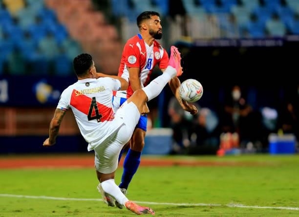 Alberto Espinola of Paraguay competes for the ball against Anderson Santamaria of Peru during the Quarterfinal match between Peru and Paraguay as...