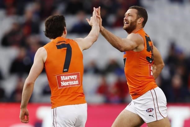 Sam J. Reid of the Giants celebrates a goal with Lachie Ash during the 2021 AFL Round 16 match between the Melbourne Demons and the GWS Giants at the...