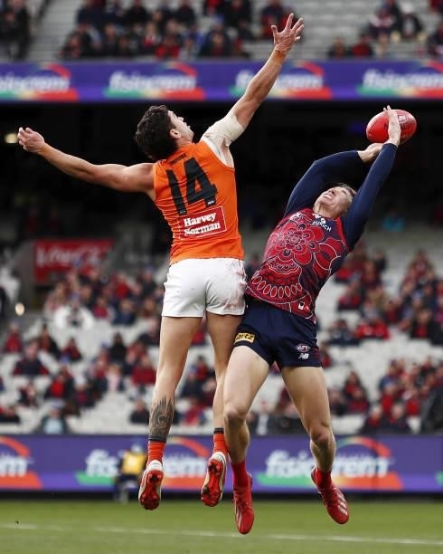 Tim Taranto of the Giants and Jayden Hunt of the Demons compete for the ball during the 2021 AFL Round 16 match between the Melbourne Demons and the...