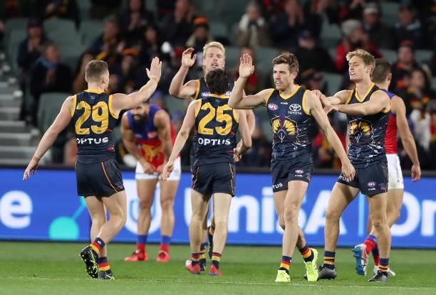 Paul Seedsman of the Crows celebrates a goal with his teammates during the 2021 AFL Round 16 match between the Adelaide Crows and the Brisbane Lions...