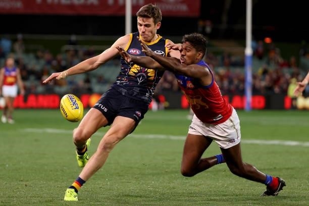 Paul Seedsman of the Crows is tackled by Keidean Coleman of the Lions during the 2021 AFL Round 16 match between the Adelaide Crows and the Brisbane...