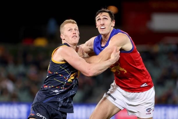Reilly O'Brien of the Crows competes with Oscar McInerney of the Lions during the 2021 AFL Round 16 match between the Adelaide Crows and the Brisbane...