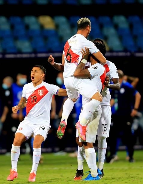Miguel Trauco of Peru celebrates with his teammates after winning the penalty shootout during the Quarterfinal match between Peru and Paraguay as...