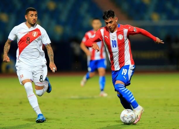 Santiago Arzamendia of Paraguay controls the ball against Sergio Pena of Peru during the Quarterfinal match between Peru and Paraguay as part of...