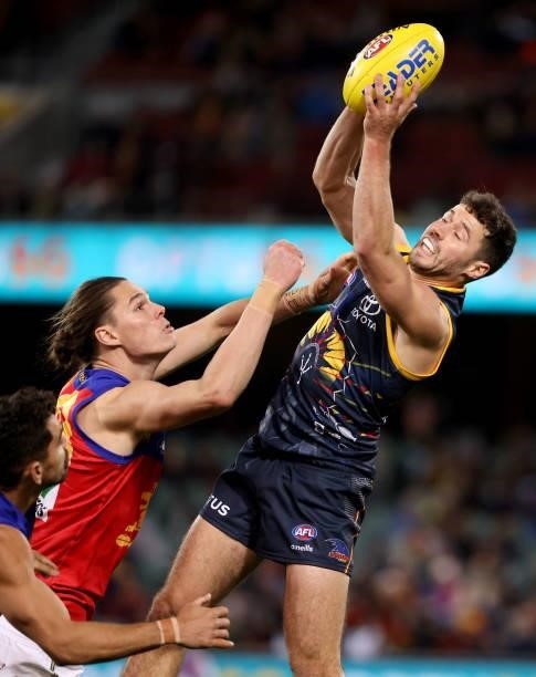 Eric Hipwood of the Lions tackles Luke Brown of the Crows during the 2021 AFL Round 16 match between the Adelaide Crows and the Brisbane Lions at...