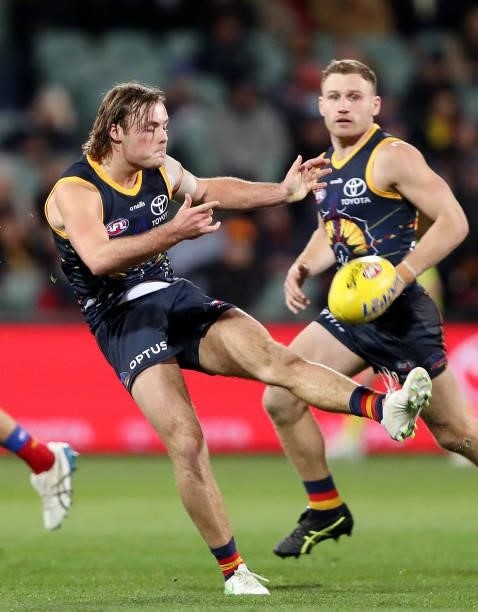 Debutant Luke Pedlar of the Crows kicks the ball during the 2021 AFL Round 16 match between the Adelaide Crows and the Brisbane Lions at Adelaide...
