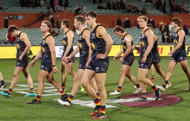 Crows players walk off after the loss during the 2021 AFL Round 16 match between the Adelaide Crows and the Brisbane Lions at Adelaide Oval on July...