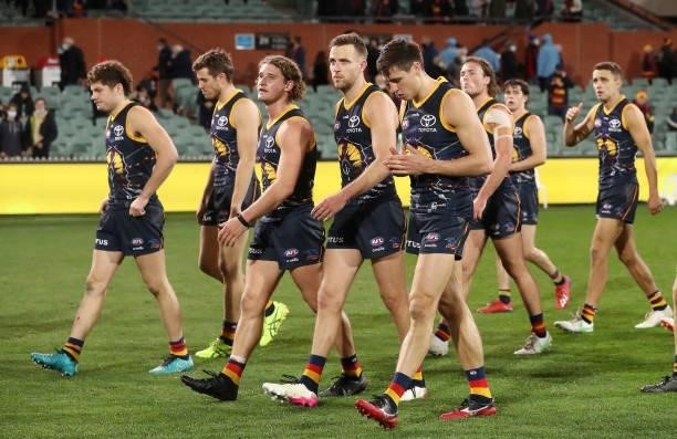 Crows players walk off after the loss during the 2021 AFL Round 16 match between the Adelaide Crows and the Brisbane Lions at Adelaide Oval on July...