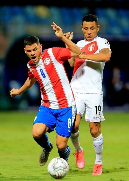 Richard Sanchez of Paraguay competes for the ball against Yoshimar Yotun of Peru during the Quarterfinal match between Peru and Paraguay as part of...