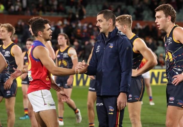 Former team mates, Charlie Cameron of the Lions and Taylor Walker after the match during the 2021 AFL Round 16 match between the Adelaide Crows and...