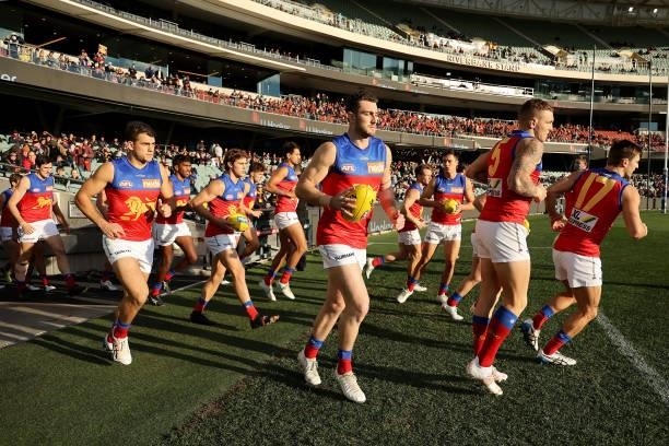 The Lions run out during the 2021 AFL Round 16 match between the Adelaide Crows and the Brisbane Lions at Adelaide Oval on July 3, 2021 in Adelaide,...
