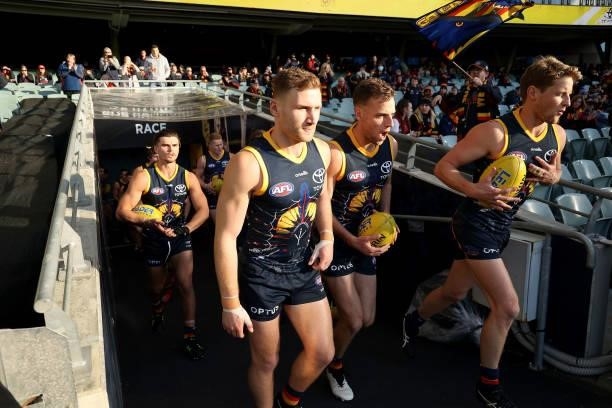 The Crows run out during the 2021 AFL Round 16 match between the Adelaide Crows and the Brisbane Lions at Adelaide Oval on July 3, 2021 in Adelaide,...