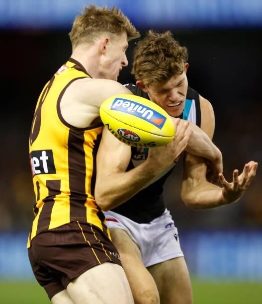 Mitch Georgiades of the Power is tackled by Sam Frost of the Hawks during the 2021 AFL Round 16 match between the Hawthorn Hawks and the Port...