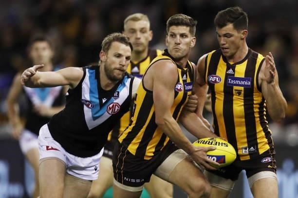 Luke Breust of the Hawks is tackled by Trent McKenzie of the Power during the 2021 AFL Round 16 match between the Hawthorn Hawks and the Port...