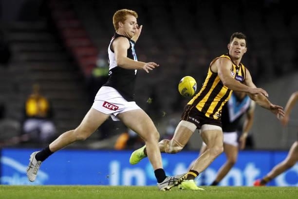 Willem Drew of the Power in action ahead of Jaeger O'Meara of the Hawks during the 2021 AFL Round 16 match between the Hawthorn Hawks and the Port...