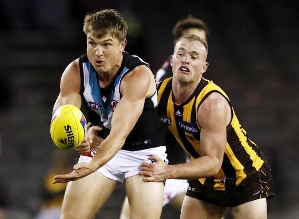 Ollie Wines of the Power is tackled by Tom Mitchell of the Hawks during the 2021 AFL Round 16 match between the Hawthorn Hawks and the Port Adelaide...