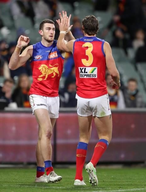 Daniel McStay of the Lions celebrates a goal with team mate Joe Daniher during the 2021 AFL Round 16 match between the Adelaide Crows and the...