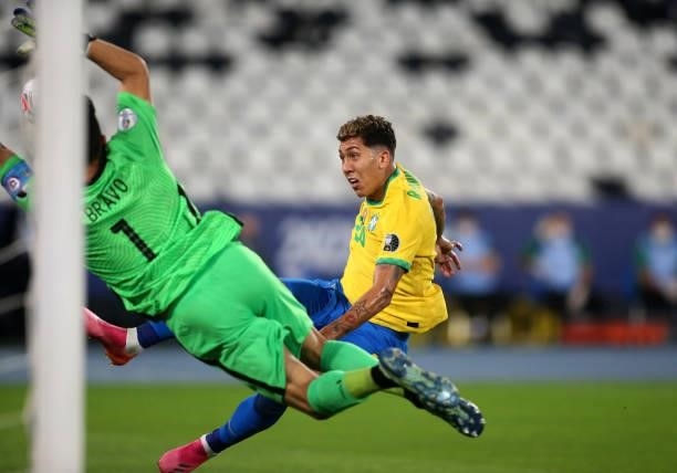 Roberto Firmino of Brazil competes for the ball with Claudio Bravo of Chile ,during the Quarterfinal match between Brazil and Chile as part of...