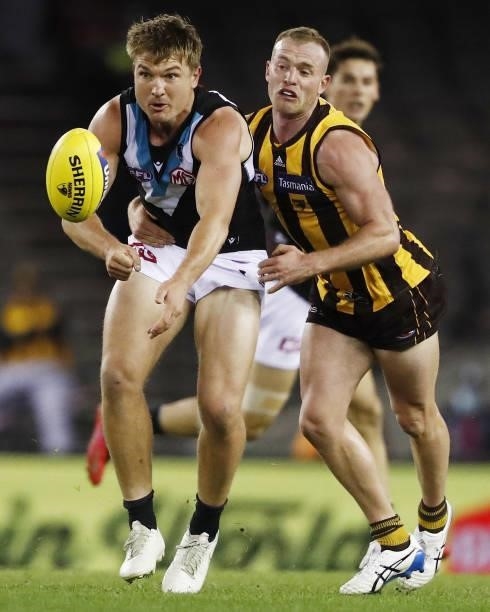 Ollie Wines of the Power is tackled by Tom Mitchell of the Hawks during the 2021 AFL Round 16 match between the Hawthorn Hawks and the Port Adelaide...