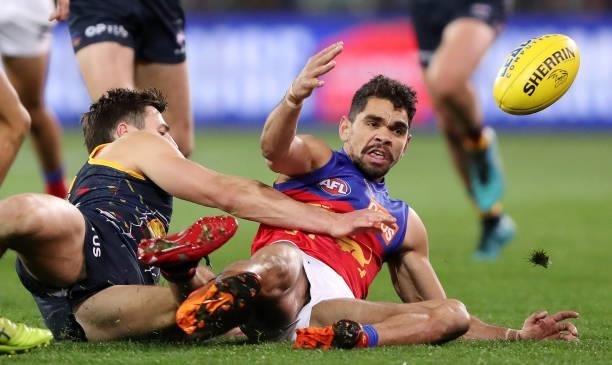 Jake Kelly of the Crows brings down Charlie Cameron of the Lions during the 2021 AFL Round 16 match between the Adelaide Crows and the Brisbane Lions...