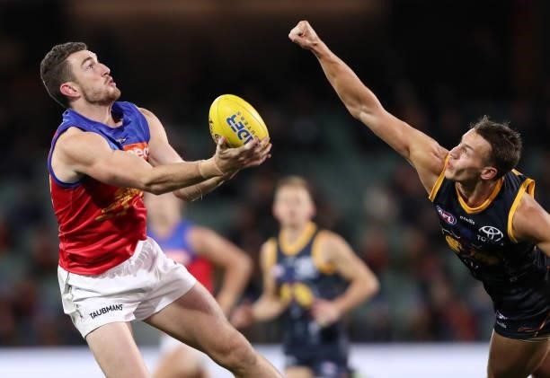 Daniel McStay of the Lions marks the ball from Tom Doedee of the Crows during the 2021 AFL Round 16 match between the Adelaide Crows and the Brisbane...