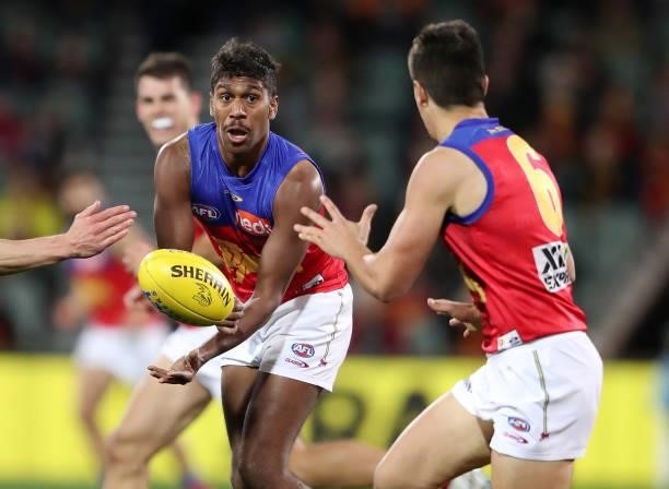 Keidean Coleman of the Lions handpasses the ball to Hugh McCluggage during the 2021 AFL Round 16 match between the Adelaide Crows and the Brisbane...