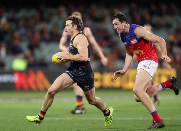 Paul Seedsman of the Crows and Oscar McInerney of the Lions during the 2021 AFL Round 16 match between the Adelaide Crows and the Brisbane Lions at...