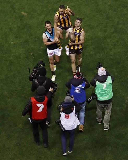 Shaun Burgoyne of the Hawks is chaired off the ground after his 400th game by Travis Boak of the Power and Liam Shiels of the Hawks during the 2021...