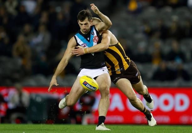 Sam Mayes of the Power is tackled by James Worpel of the Hawks during the 2021 AFL Round 16 match between the Hawthorn Hawks and the Port Adelaide...