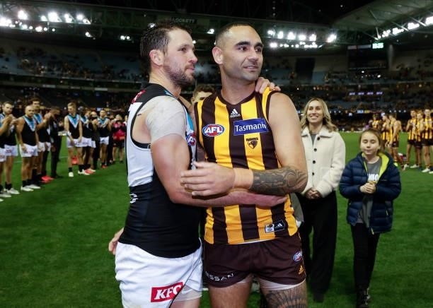 Shaun Burgoyne of the Hawks is embraced by Travis Boak of the Power after his 400th match during the 2021 AFL Round 16 match between the Hawthorn...