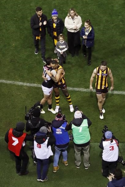 Shaun Burgoyne of the Hawks hugs Travis Boak of the Power after being chaired off the ground for his 400th game during the 2021 AFL Round 16 match...