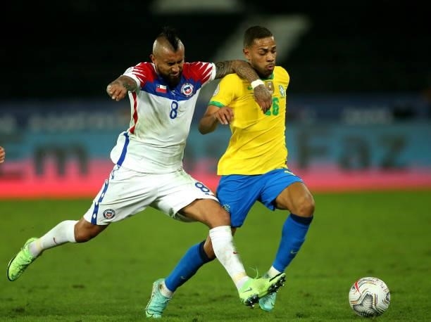 Renan Lodi of Brazil competes for the ball with Arturo Vidal of Chile ,during the Quarterfinal match between Brazil and Chile as part of Conmebol...