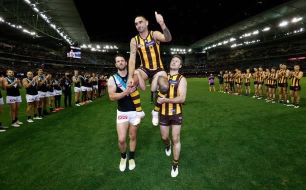 Shaun Burgoyne of the Hawks is chaired from the field after his 400th match by Travis Boak of the Power and Liam Shiels of the Hawks during the 2021...