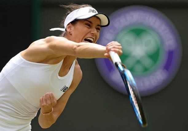 Romania's Sorana Cirstea serves against Britain's Emma Raducanu during their women's singles third round match on the sixth day of the 2021 Wimbledon...