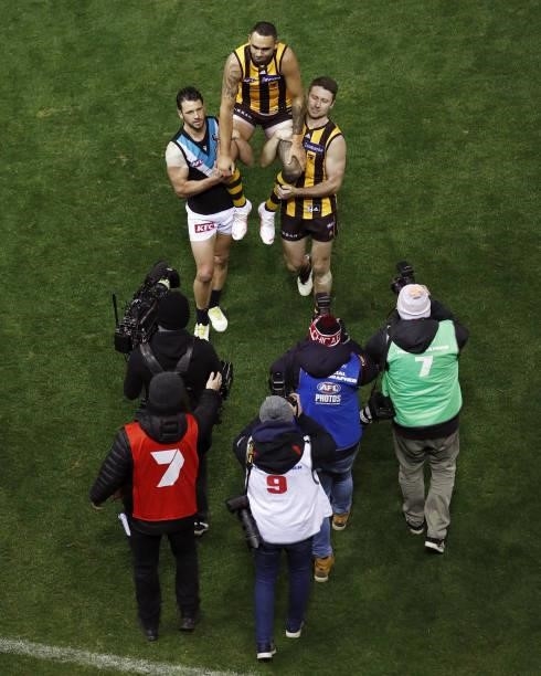 Shaun Burgoyne of the Hawks is chaired off the ground after his 400th game by Travis Boak of the Power and Liam Shiels of the Hawks during the 2021...