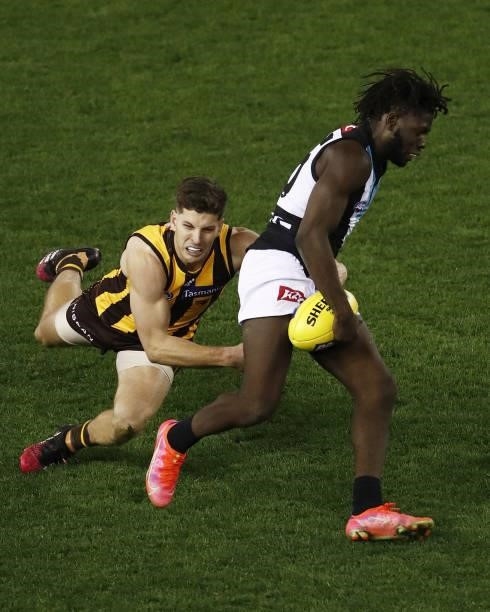 Martin Frederick of the Power is tackled by Luke Breust of the Hawks during the 2021 AFL Round 16 match between the Hawthorn Hawks and the Port...