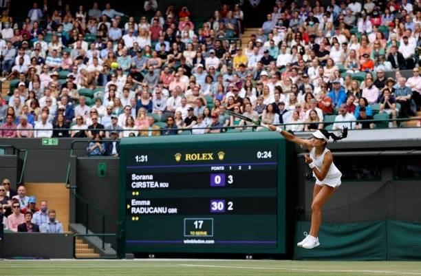 Britain's Emma Raducanu serves against Romania's Sorana Cirstea during their women's singles third round match on the sixth day of the 2021 Wimbledon...