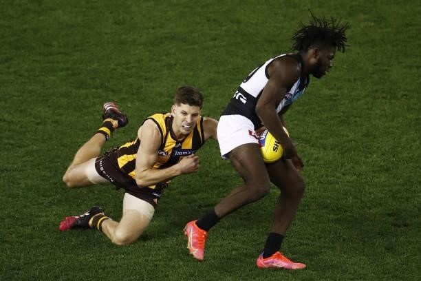 Martin Frederick of the Power is tackled by Luke Breust of the Hawks during the 2021 AFL Round 16 match between the Hawthorn Hawks and the Port...