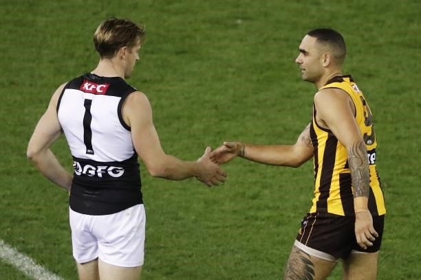 Tom Jonas of the Power shakes hands with Shaun Burgoyne of the Hawks during the 2021 AFL Round 16 match between the Hawthorn Hawks and the Port...