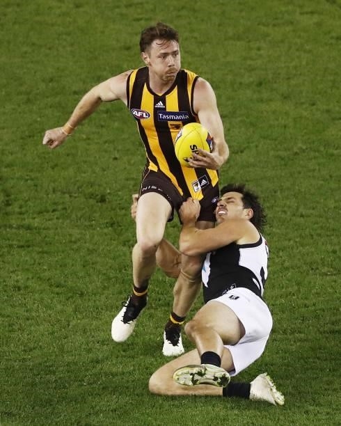 Lachlan Bramble of the Hawks is tackled by Sam Mayes of the Power during the 2021 AFL Round 16 match between the Hawthorn Hawks and the Port Adelaide...