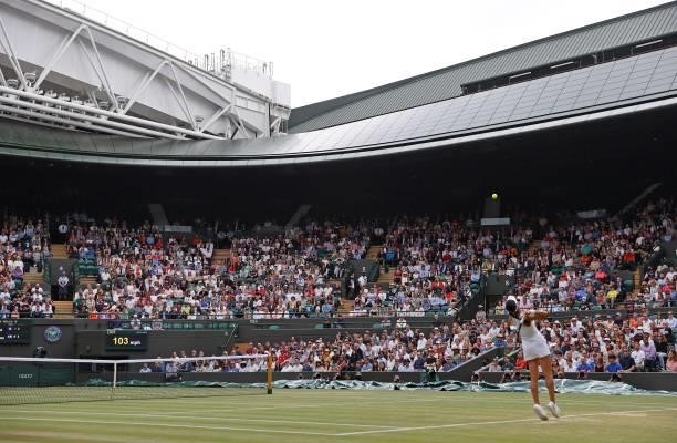 Spectators watch as Britain's Emma Raducanu serves against Romania's Sorana Cirstea during their women's singles third round match on the sixth day...