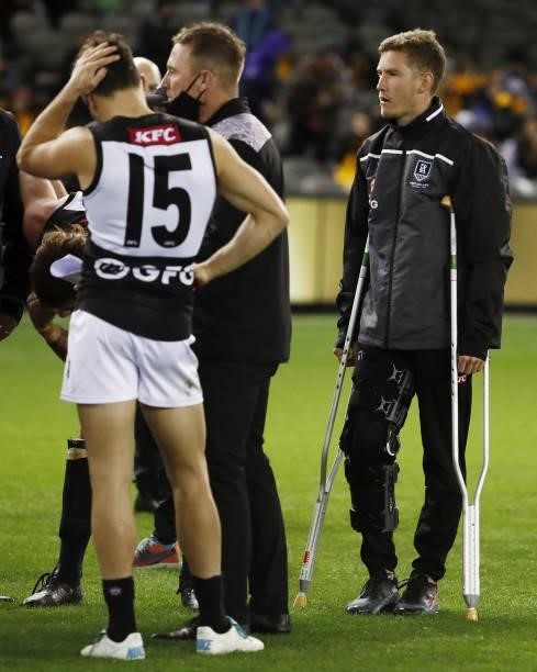 Kane Farrell of the Power is seen on crutches during the 2021 AFL Round 16 match between the Hawthorn Hawks and the Port Adelaide Power at Marvel...