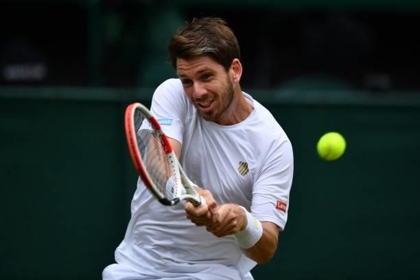 Britain's Cameron Norrie returns against Switzerland's Roger Federer during their men's singles third round match on the sixth day of the 2021...