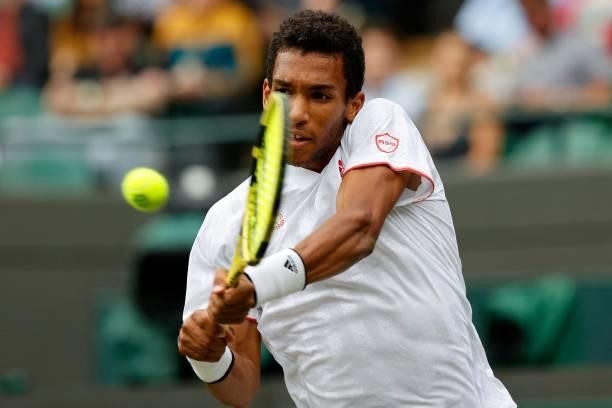 Canada's Felix Auger-Aliassime returns against Australia's Nick Kyrgios during their men's singles third round match on the sixth day of the 2021...