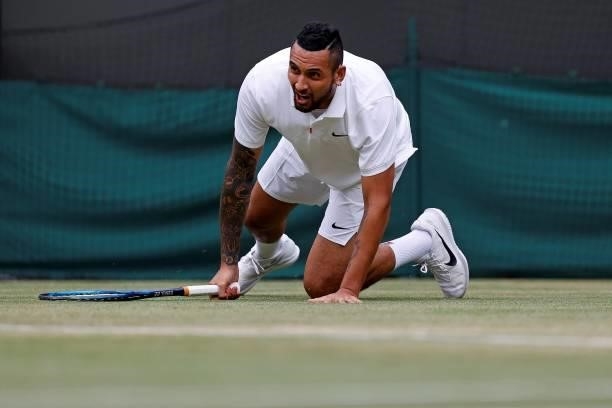 Australia's Nick Kyrgios slips on the grass as he plays against Canada's Felix Auger-Aliassime during their men's singles third round match on the...