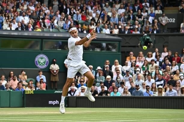 Switzerland's Roger Federer returns against Britain's Cameron Norrie during their men's singles third round match on the sixth day of the 2021...