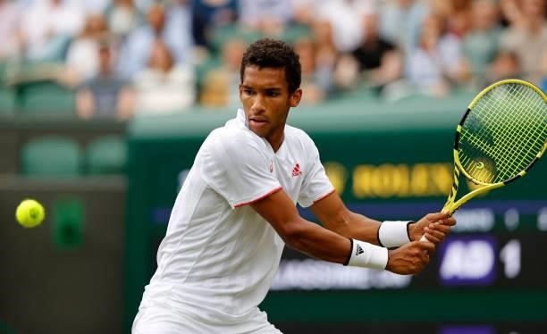 Canada's Felix Auger-Aliassime returns against Australia's Nick Kyrgios during their men's singles third round match on the sixth day of the 2021...
