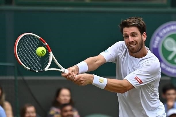 Britain's Cameron Norrie returns against Switzerland's Roger Federer during their men's singles third round match on the sixth day of the 2021...